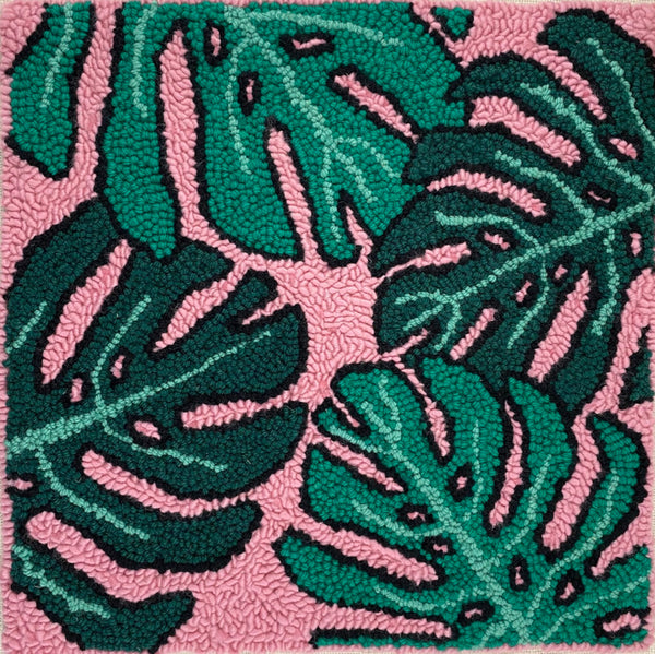 up close shot of monstera punch needle pillow