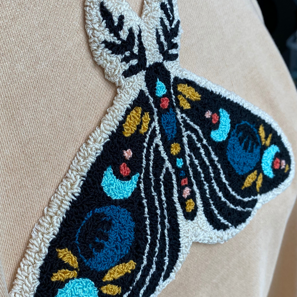 side view of celestial moth punch needle embroidery design