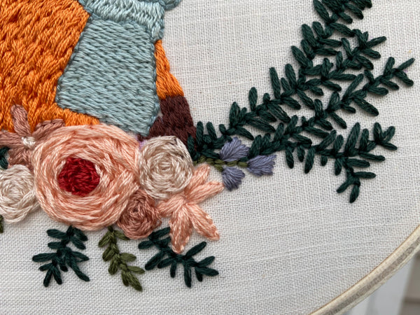 Up close shot of embroidered flowers in Fox in a Scarf punch needle design