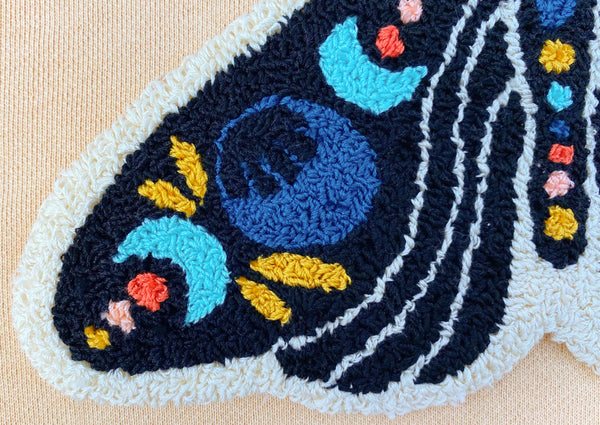 up close shot of the bottom left wing of celestial moth punch needle design