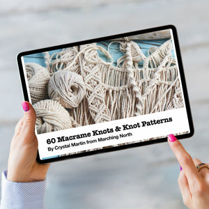 Macrame Knots ebook cover on a black iPad with a womans finger pointing at it