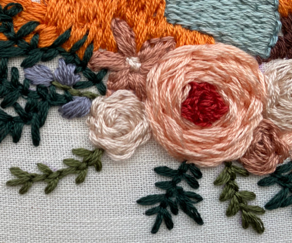 Up close shot of embroidered flowers in Fox in a Scarf punch needle design