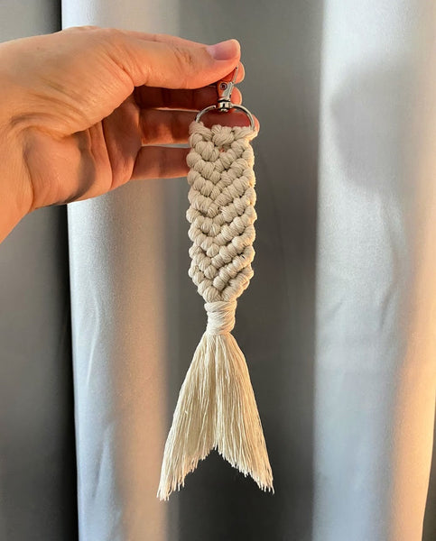 woman holding up finished macrame mermaid tail keychain