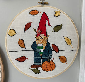 Finished pumpkin spice Pete punch needle design in a wooden hoop